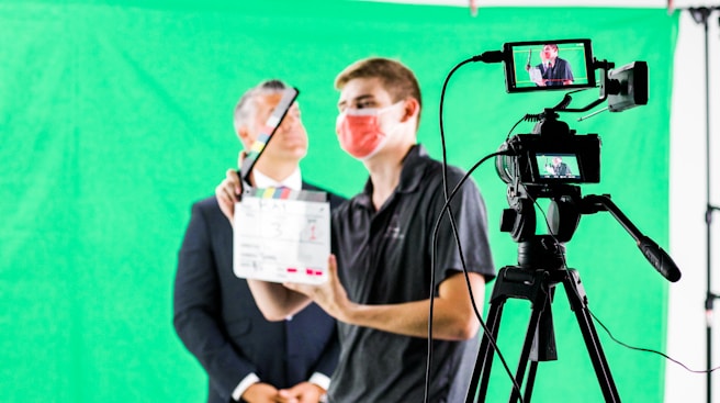 a man holding a camera and a video camera